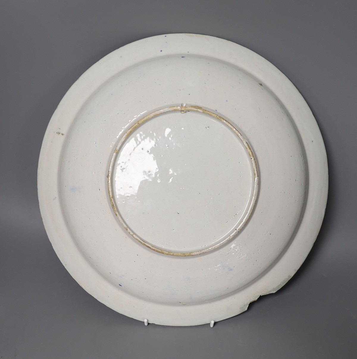 A Delft blue and white charger, early 18th century, 35.5cm diameter (a.f.)